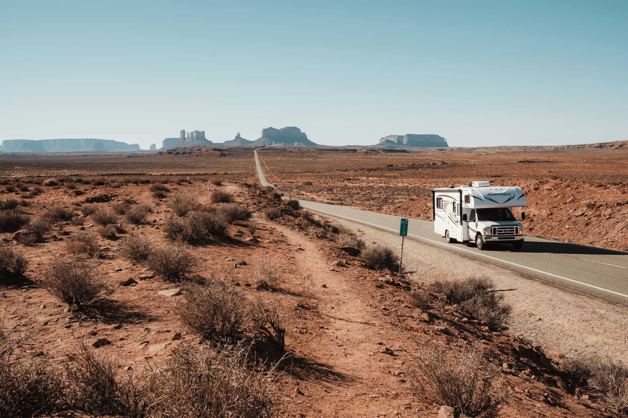 Imoova relocation campervan driving through Monument Valley in the USA